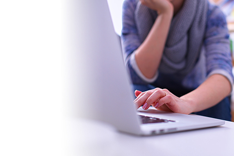 Image of person typing on a laptop.