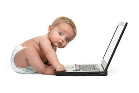 Image: infant utilizing a laptop.