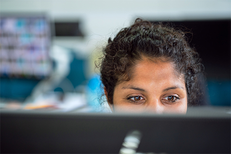 Image of woman staring at a computer screen.