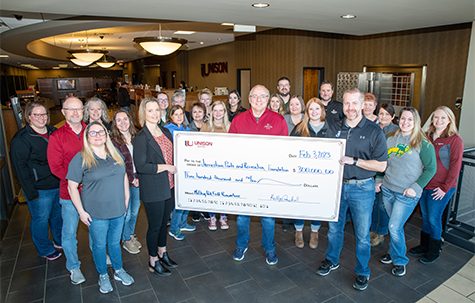 Image of Unison Bank employees during check presentation of a $300,000 donation to the Jamestown Parks and Recreation Foundation for the upcoming McElroy Park field renovations.