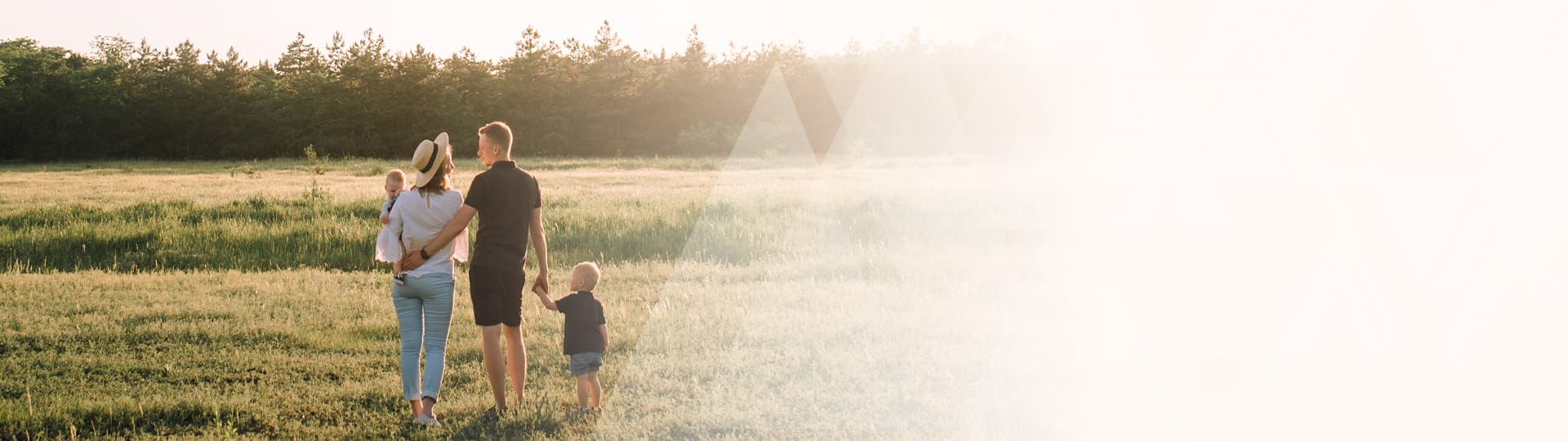 Homepage banner image of a family in a field.